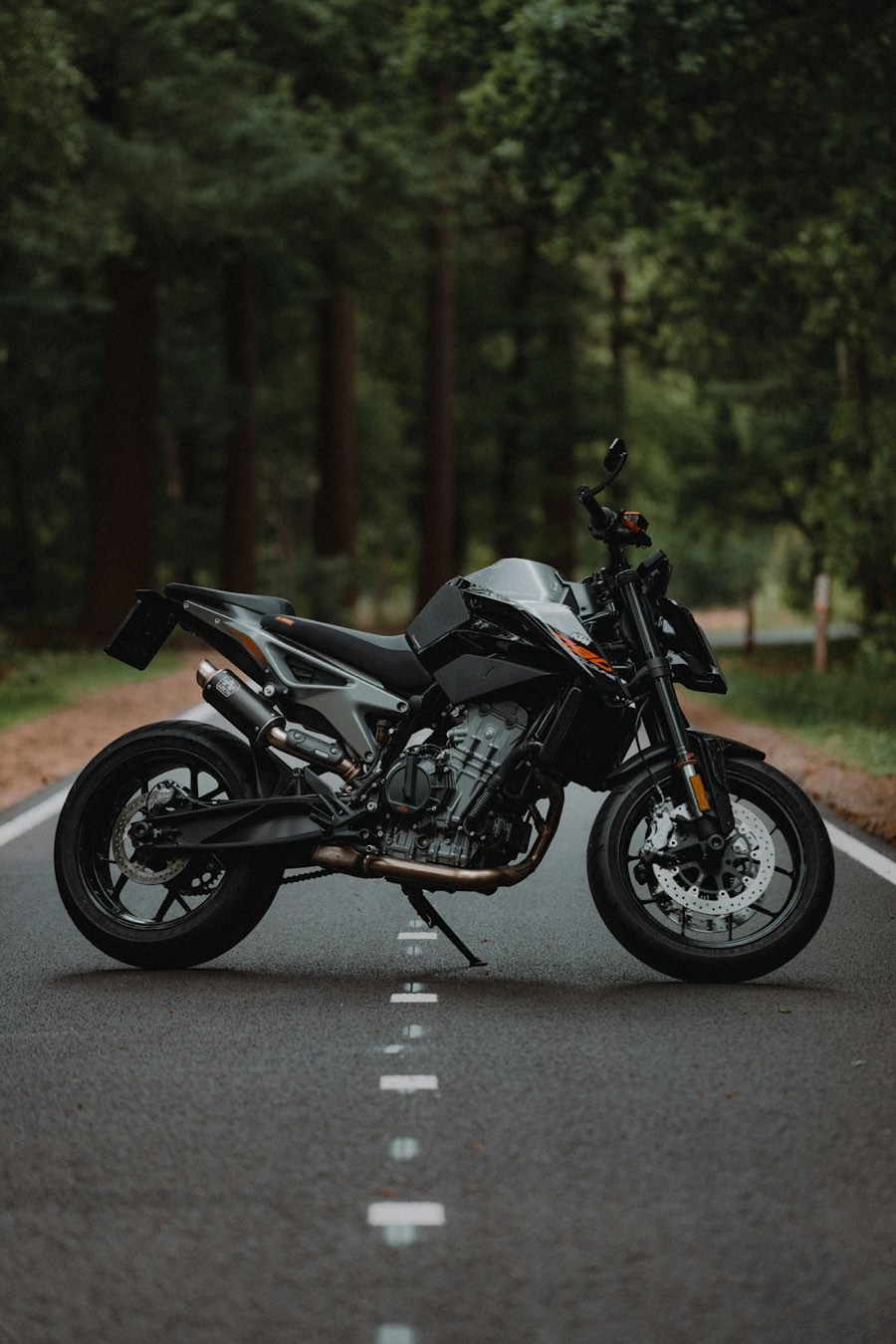 A motorcycle parked on an empty lane-marked road